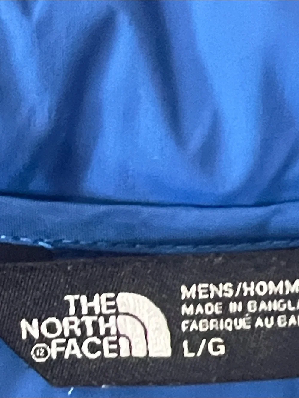 The North Face Black Quilted Down Vest with Blue Lining and Orange Logo